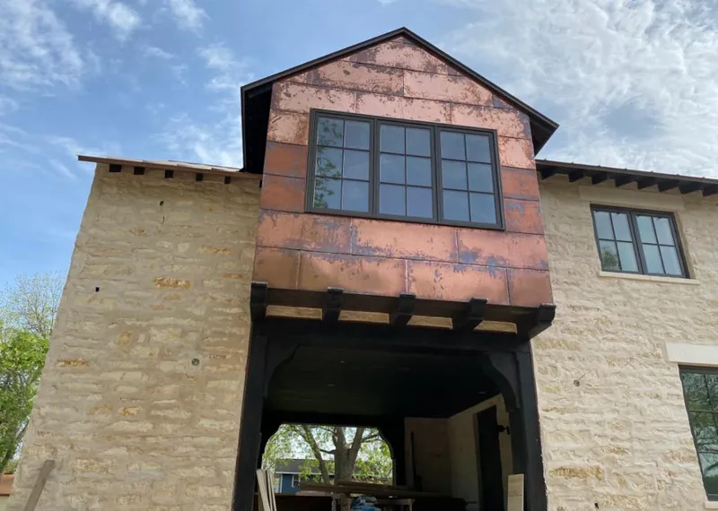 Copper metal panel facade on a stone building for Skylight Installation in Sea Cliff