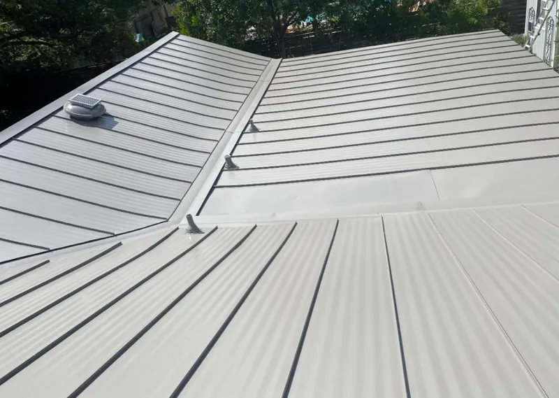 Solar attic fan installed on a metal roof for Roof Ventilation in Sea Cliff