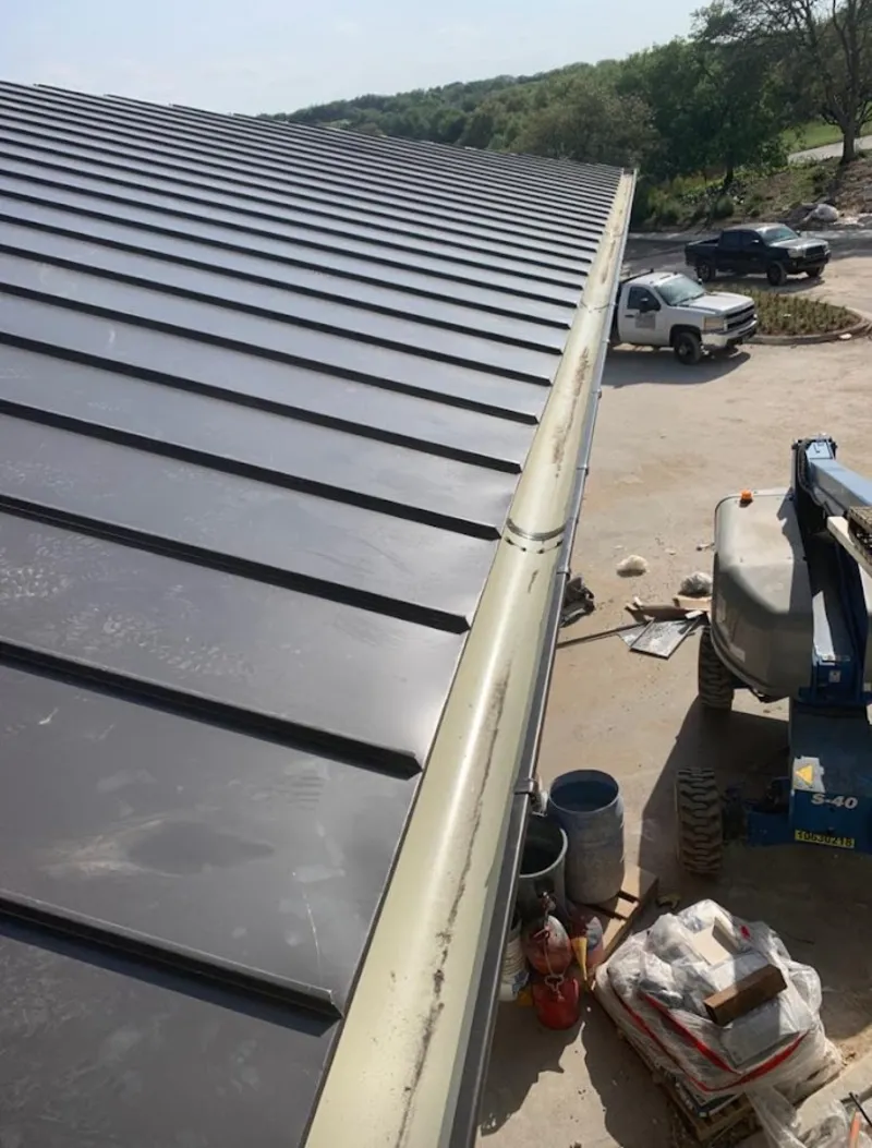 Standing seam panel and gutter detail on a metal roofing jobsite in Sea Cliff